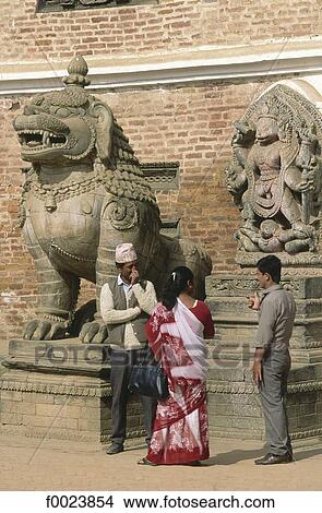 Picture - Nepal, Bhaktapur, Durbar Square, Royal Palace, statues of a lion and a divinity. Fotosearch