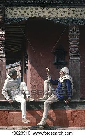 Stock Image - Nepal, Kathmandu, Durbar Square, men discussing. Fotosearch