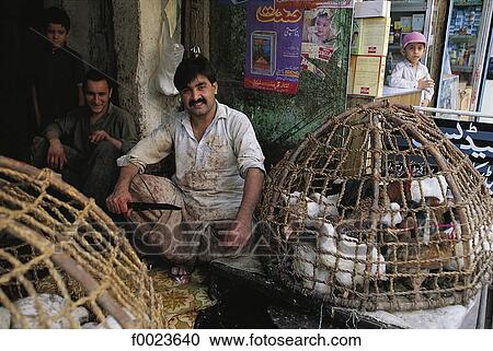 Stock Image - Pakistan, North-West Frontier Province, Peshawar, old city bazaar, selling fowls. Fotosearch