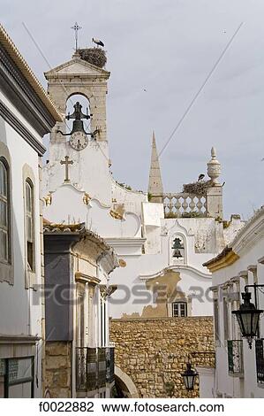 Stock Image - Portugal, Algarve, Faro, church and stork nests. Fotosearch