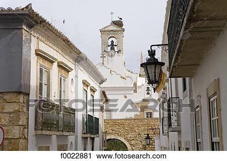 Stock Image - Portugal, Algarve, Faro, habitations and church. Fotosearch