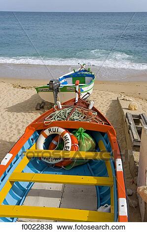 Stock Photo - Portugal, Algarve, near Albufeira, beach, coloured fishing boats. Fotosearch