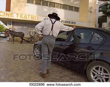 Stock Photograph - Portugal, Algarve, Tavira, man dressed in traditional costume and modern car. Fotosearch
