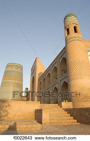 Stock Image - Uzbekistan, Khiva, Mouhammed Rakhim Khan Madrasah and Kalta Minor minaret. Fotosearch