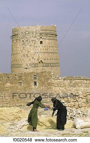 Stock Photo - Yemen, Mantakat Karen, two women winnowing barley. Fotosearch