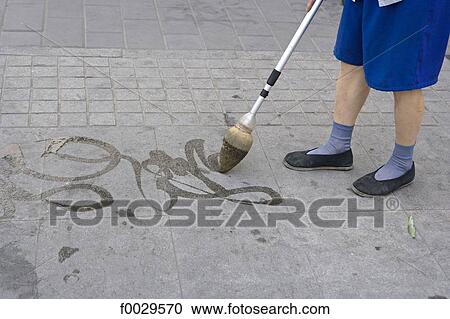 Stock Image - China, Beijing, Beihai Park, Chinese calligraphy on the ground. Fotosearch