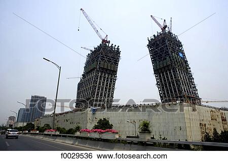 Stock Photograph - China, Beijing, construction of the Chinese television CCTV headquarters designed by Rem Koolhaas. Fotosearch
