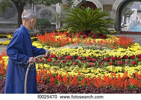 Stock Image - China, Beijing, Dong Yue Miao temple, gardener. Fotosearch
