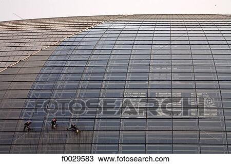 Stock Image - China, Beijing, opera house, architectural detail, cleaning of the glass surface. Fotosearch