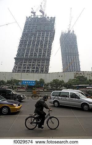 Picture - China, Beijing, traffic by the construction of the Chinese television CCTV headquarters designed by Rem Koolhaas. Fotosearch