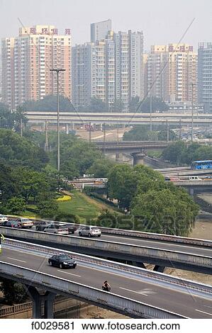 Stock Image - China, Beijing, urban highways and habitations buildings seen from the ramparts. Fotosearch