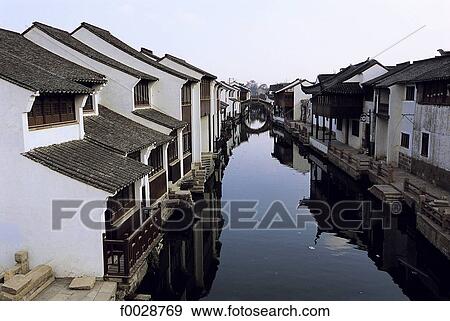 Stock Photo - China, Jiangsu, Suzhou, ancient houses lining a canal. Fotosearch
