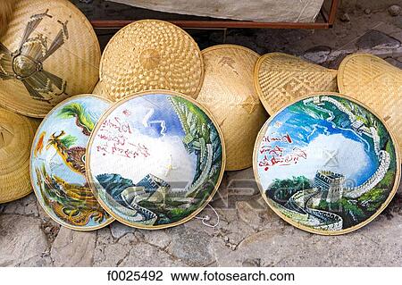 Stock Image - China, near Beijing, Mu Tian Yu, the Great Wall, traditional hats for sale. Fotosearch