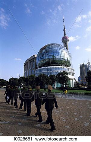 Stock Image - China, Shanghai, new town of Pudong, soldiers marching in step. Fotosearch