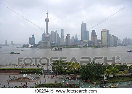 Stock Photography - China, Shanghai, the Bund promenade, Huangpu River and new town of Pudong. Fotosearch