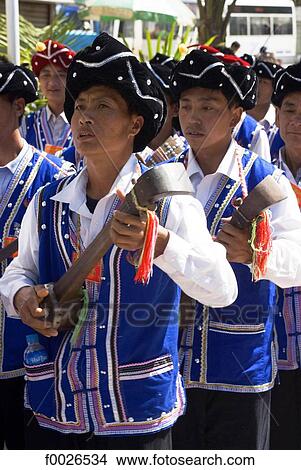 Picture - China, Yunnan, Lancang, Aini men playing the traditional string instrument. Fotosearch