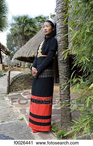 Stock Image - China, Yunnan, near Kunming, Yunnan Nationalities Village, young Va woman. Fotosearch