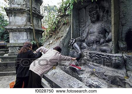 China, Zhejiang, Hangzhou, Lingyin temple, women touching the foot of a Buddha statue for good luck in View Large Photo Image Stock Image - China, Zhejiang, Hangzhou, Lingyin temple, women touching the foot of a Buddha statue for good luck in . Fotosearch