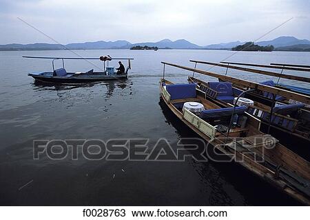 China, Zhejiang, Hangzhou, tour boats on the great lake View Large Photo Image Stock Image - China, Zhejiang, Hangzhou, tour boats on the great lake. Fotosearch