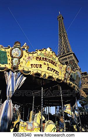 Stock Image - France, Paris, merry-go-round at the foot of Eiffel Tower. Fotosearch