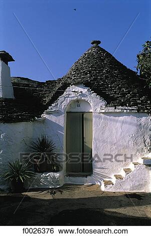 Stock Photograph - Italy, Apulia, Alberobello, traditional dwelling called "Trullo". Fotosearch