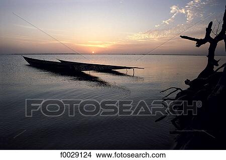Picture - Mali, Debo lake, pirogues at sunset. Fotosearch