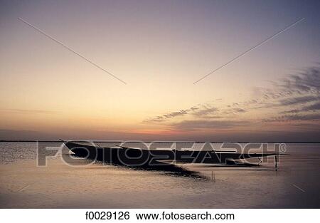 Stock Photograph - Mali, Debo lake, pirogues at sunset. Fotosearch