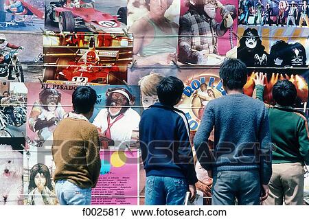 Stock Photo - Peru, Lima, children looking at posters. Fotosearch