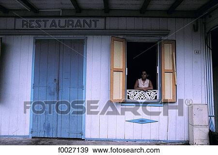 Stock Photo - Reunion, Salazie cirque, Hell-Bourg, young woman at a restaurant window. Fotosearch