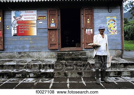 Stock Photo - Reunion, Salazie, local resident behind a shop. Fotosearch