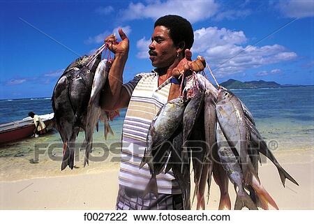 Stock Image - Seychelles, La Digue, return from fishing. Fotosearch