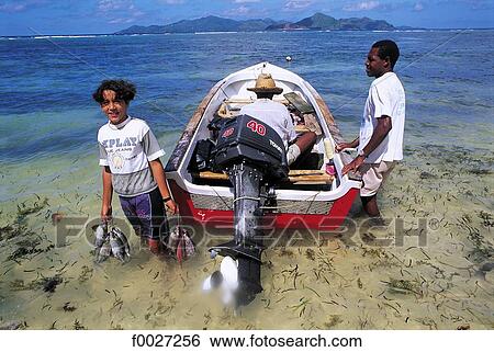 Stock Photograph - Seychelles, La Digue, return from fishing. Fotosearch