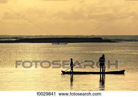 Togo, Aného, the lagoon, fishermen at dusk View Large Photo Image Stock Image - Togo, Aného, the lagoon, fishermen at dusk. Fotosearch