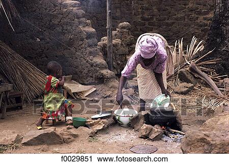 Stock Image - Togo, Bassar woman preparing the lunch. Fotosearch