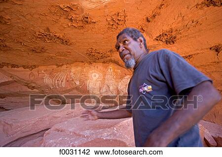 Stock Image - Australia, Northern Territory, Gunya Titjikala aborigine community, cave with aborigine drawings. Fotosearch