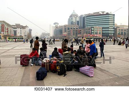 Stock Photo - China, Beijing, travellers ahead of the railway station. Fotosearch