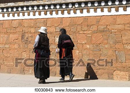 China, Gansu, Gannan, Hézuo, women by the wall of Serkhar Guthog Tibetan Buddhist monastery View Large Photo Image Stock Image - China, Gansu, Gannan, Hézuo, women by the wall of Serkhar Guthog Tibetan Buddhist monastery. Fotosearch
