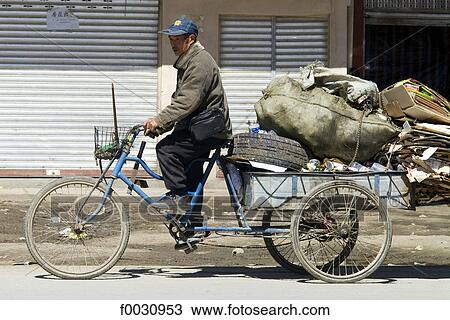 China, Gansu, man collecting garbage by bike View Large Photo Image Stock Image - China, Gansu, man collecting garbage by bike. Fotosearch