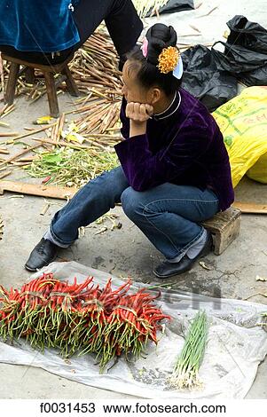 Stock Image - China, Guizhou, Leishan, market, Miao woman selling chili. Fotosearch