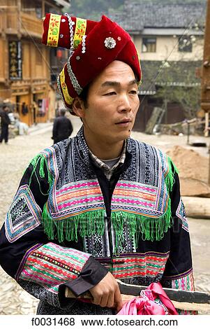 China, Guizhou, Zhaoxing village, portrait of a man in Dong traditional costume View Large Photo Image Stock Photo - China, Guizhou, Zhaoxing village, portrait of a man in Dong traditional costume. Fotosearch