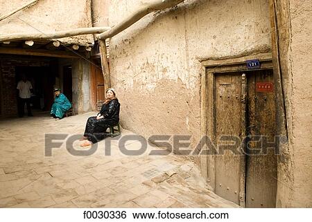 China, Xinjiang, kashgar, old city, women in front of their house View Large Photo Image Stock Photograph - China, Xinjiang, kashgar, old city, women in front of their house. Fotosearch