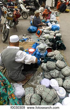Stock Photo - China, Xinjiang, kashgar, Uyghur hat sellers. Fotosearch