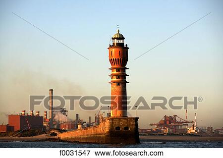 France, Nord, Opal Coast, lighthouse of Saint Pol-sur-Mer and petrochemical complex in the port of Dunkirk View Large Photo Image Stock Photo - France, Nord, Opal Coast, lighthouse of Saint Pol-sur-Mer and petrochemical complex in the port of Dunkirk. Fotosearch