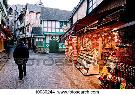 Picture - France, Normandy, Mont Saint-Michel, "Grande rue" at dusk, souvenirs shops. Fotosearch