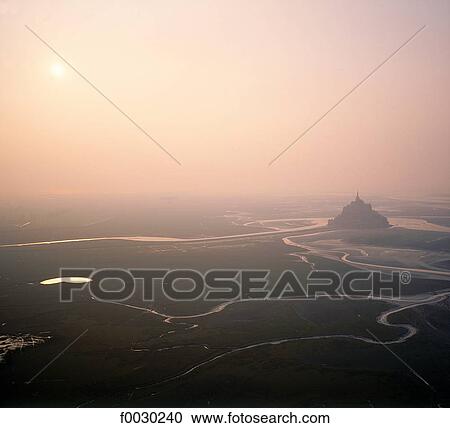 France, Normandy, Mont Saint-Michel, sunset by a misty afternoon, aerial view View Large Photo Image Stock Image - France, Normandy, Mont Saint-Michel, sunset by a misty afternoon, aerial view. Fotosearch