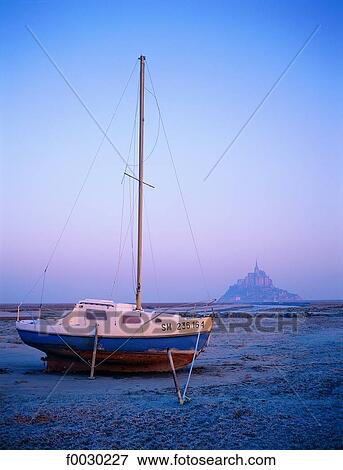 France, Normandy, Mont Saint-Michel, general view and sailing boat ashore View Large Photo Image Stock Photo - France, Normandy, Mont Saint-Michel, general view and sailing boat ashore. Fotosearch