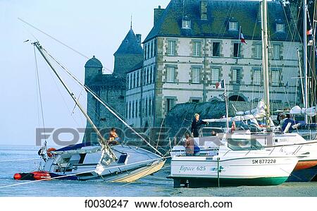 Stock Photo - France, Normandy, Mont Saint-Michel, boats ashore at the mount foot. Fotosearch