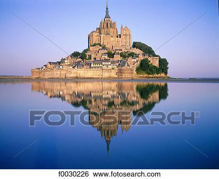France, Normandy, Mont Saint-Michel, general view at sunrise with reflection on the water View Large Photo Image Stock Photograph - France, Normandy, Mont Saint-Michel, general view at sunrise with reflection on the water. Fotosearch