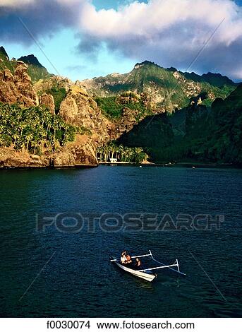 Picture - French Polynesia, Marquesas archipelago, Fatu Hiva island, outrigger in the Hanavave bay. Fotosearch