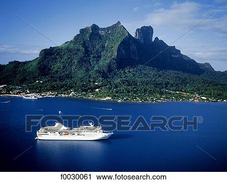 Stock Image - French Polynesia, Society Islands, Bora Bora island, cruise ship in the lagoon, aerial view. Fotosearch